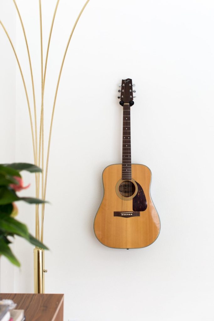 hanging guitar on wall