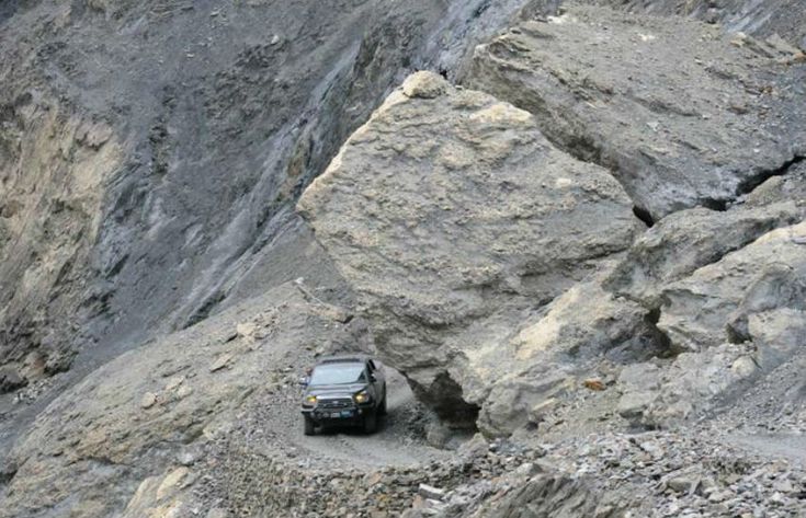 Shimshal valley road is surrounded by steep cliffs.