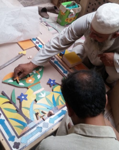Artisans create a mosaic during the restoration work