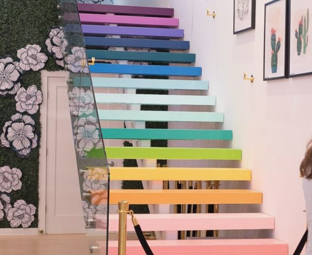 this isn an image of stairs painted in rainbow colours, which is one of the Staircase Makeover Ideas on a Budget