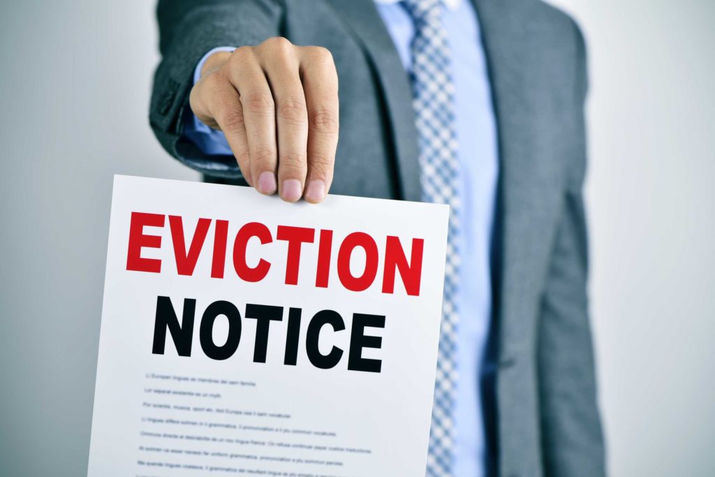 A person holding an eviction notice