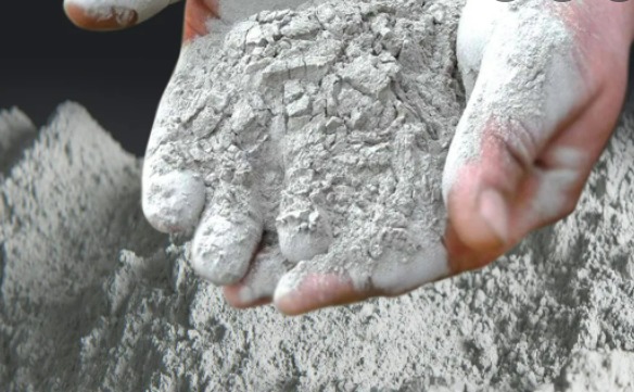 a person carrying dry cement in his hands