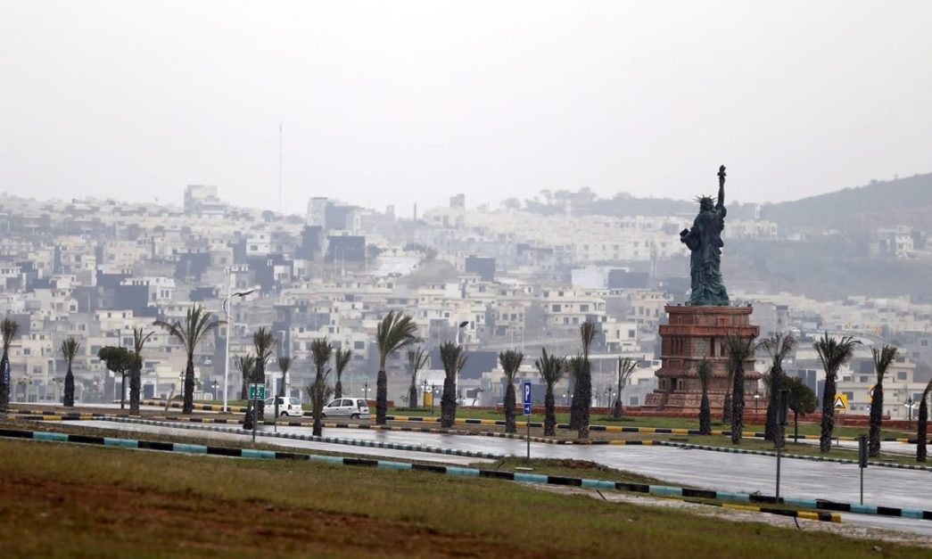 A replica of the Statue of Liberty stands on a hill overlooking the construction of new homes in Bahria Town on the outskirts of Islamabad, Pakistan 