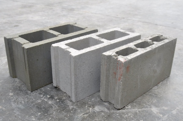 three concrete bricks placed side by side on ground