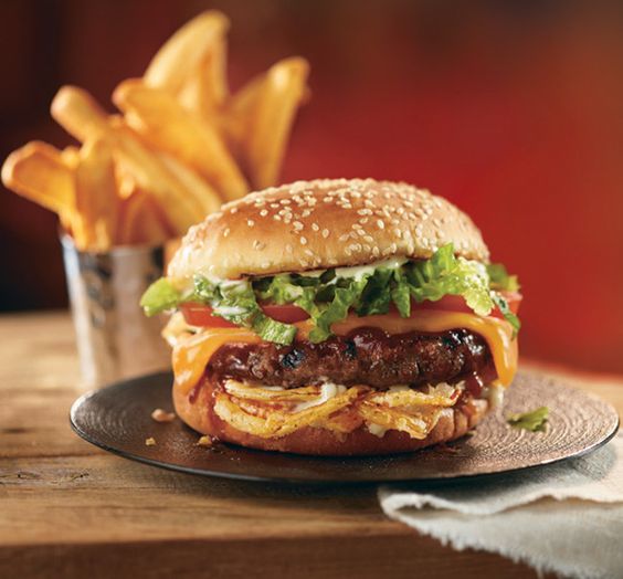 Beef patty burger served with fries at Xanders Karachi