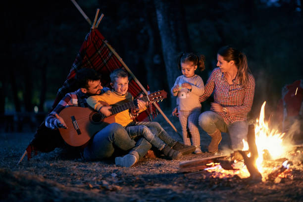 Family having fun with Guitar and bonfire