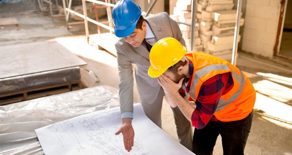 A project officer instructs a worker