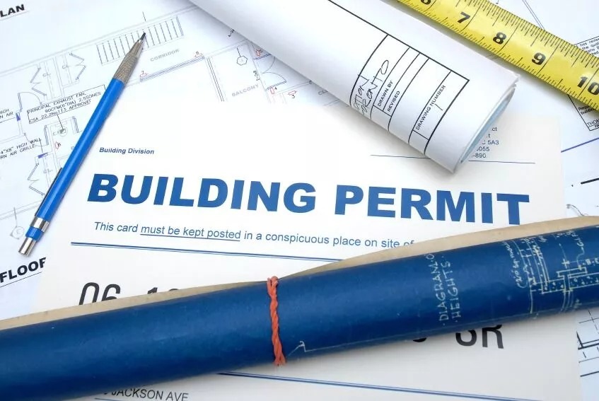Blueprints lay our a building permit to which is also known as construction permit