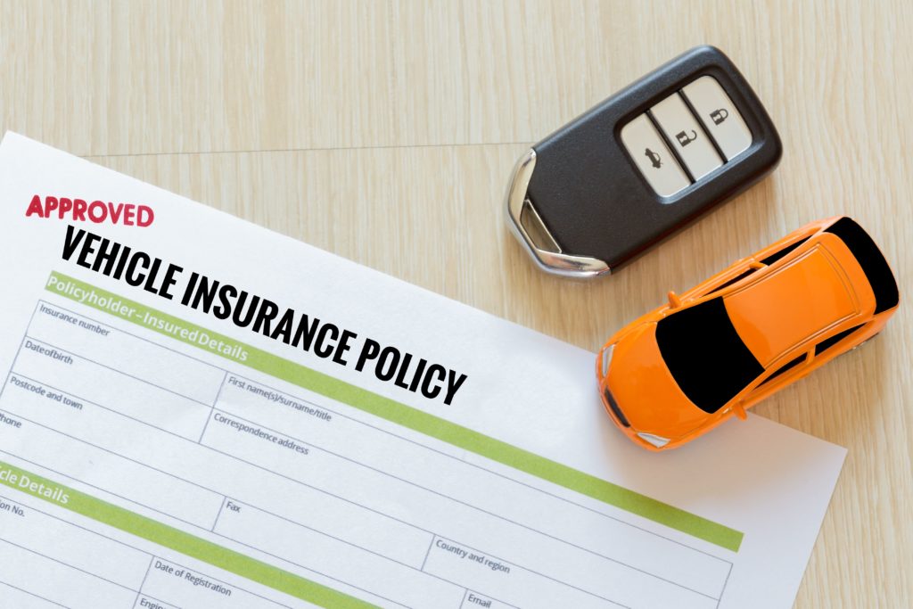 Car Insurance Policy Papers with Car Key and Toy Car