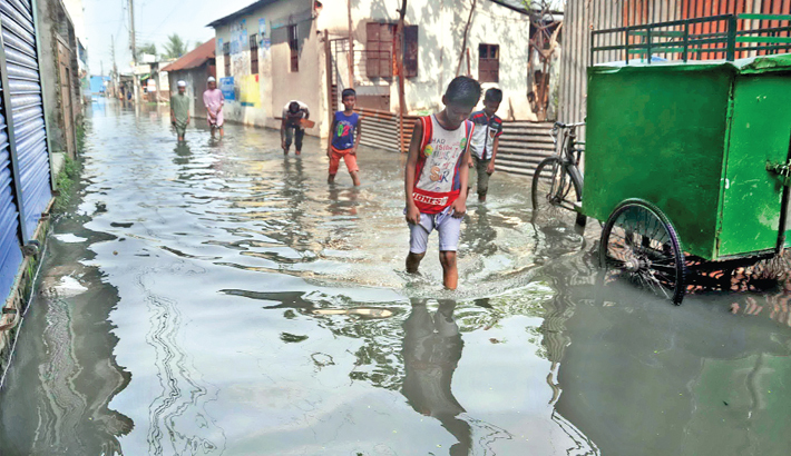 kids walking in a street submerged in water