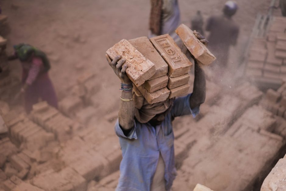 a labourer carrying bricks 