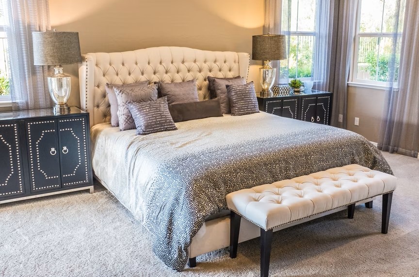 Carpeted bedroom set up in white colour with grey theme