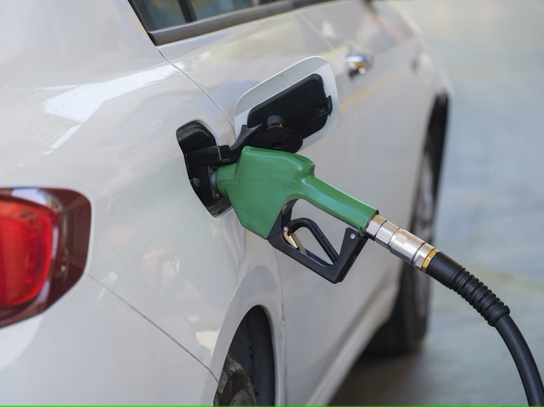 car being filled up with feul at filling station amidst rising petrol prices in Pakistan