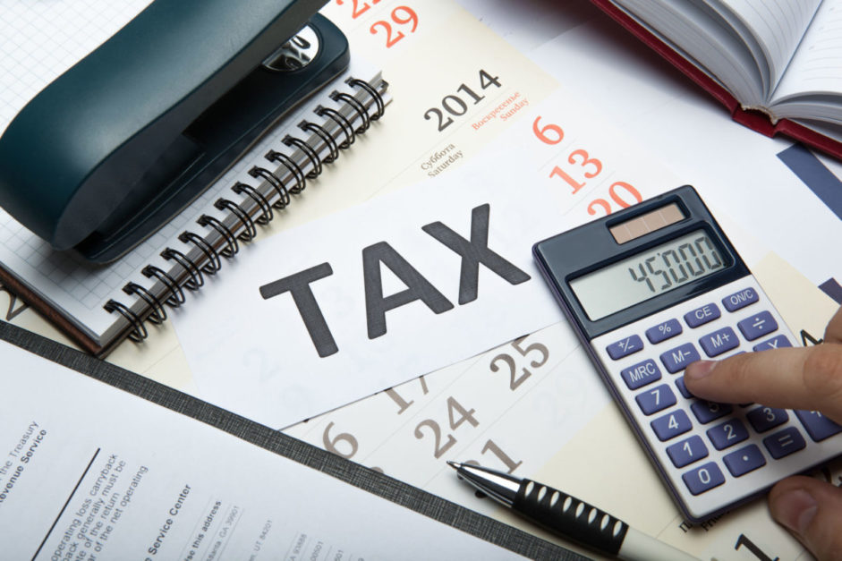 Office Table with tax papers, calculators, and pencil