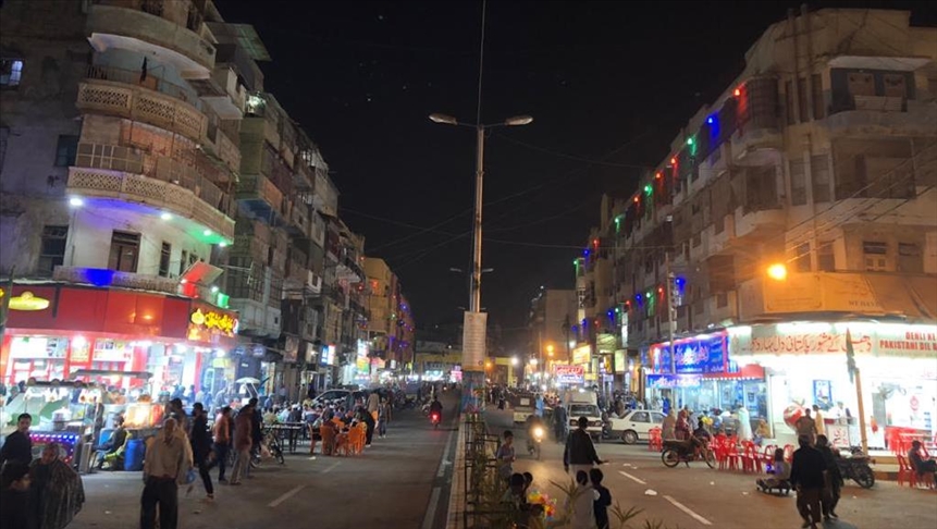 people wandering around and eating at very famous burns road in Karachi