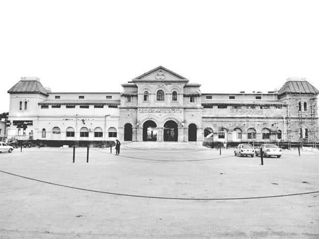 black and white view of Karachi Railway Station's entrance and parking