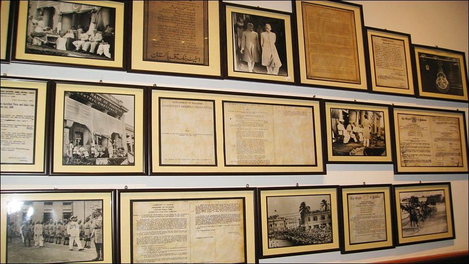 multiple frames hanging on the wall of Pakistan currency museum