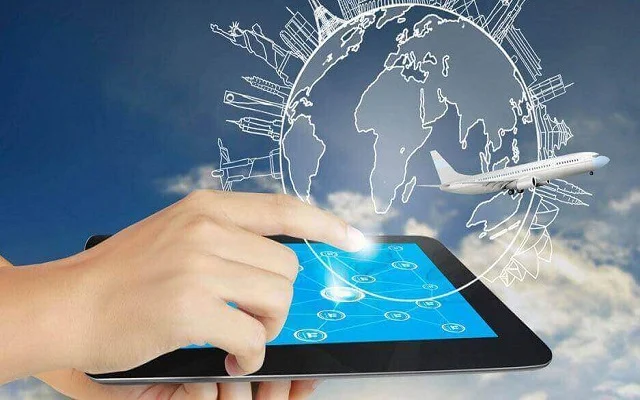 A finger tapping on a tablet, and a hologram of globe and aeroplane appearing on top of it 