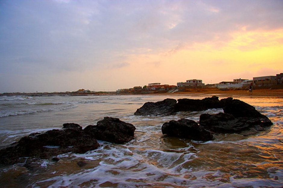 Sunset view of Hawks Bay Beach with huts in the back