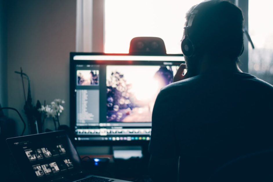 man editing image on laptop using software