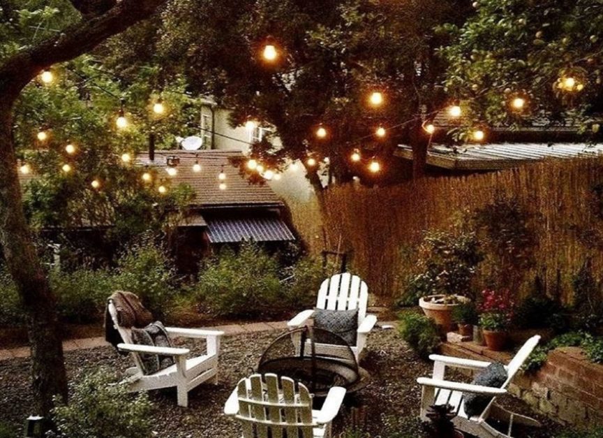 fairy lights on tree underneath chairs.