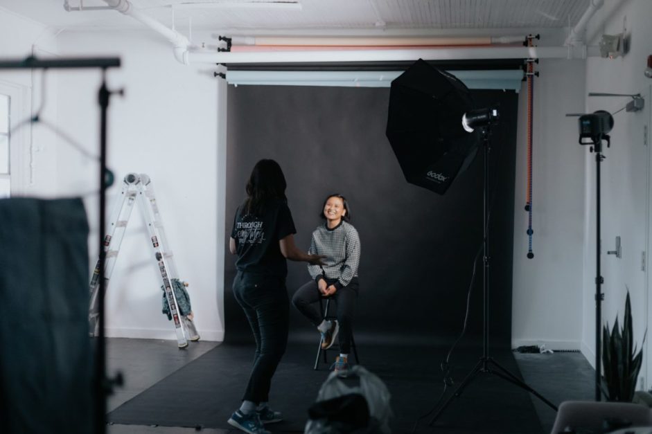 two girls setting in a home photography studio,