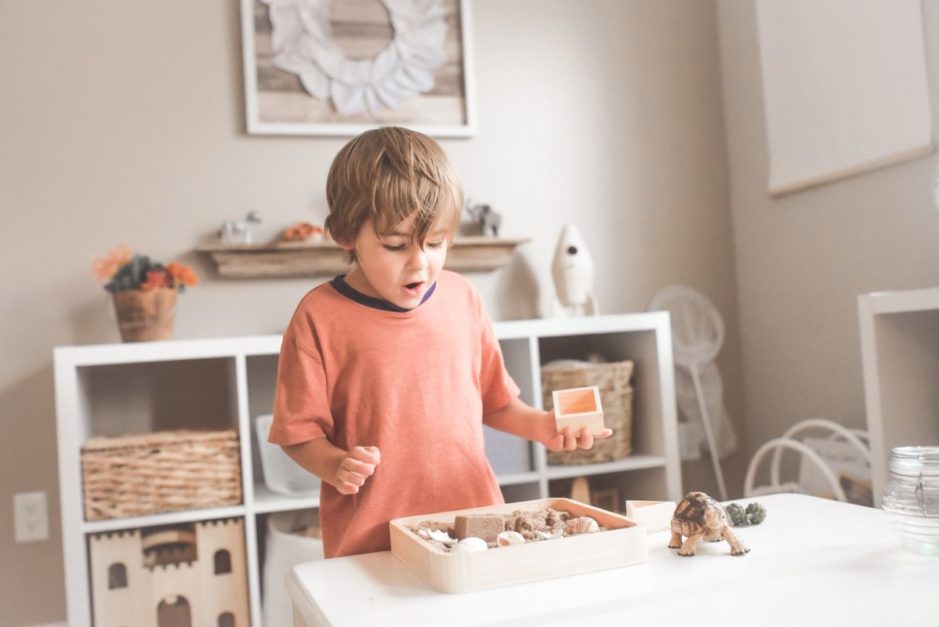 kid playing with his toy at room