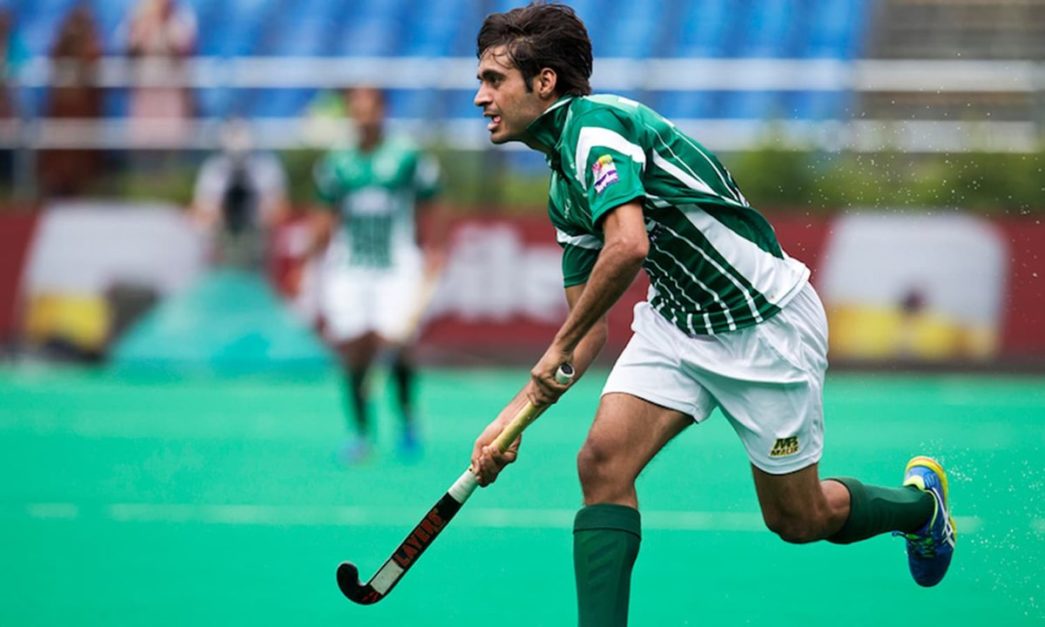 pakistani hockey player playing with his hockey stick in the field