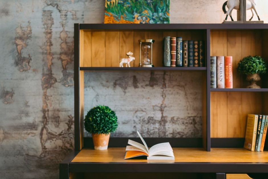 books on shelf arranged according to its hard and paperback