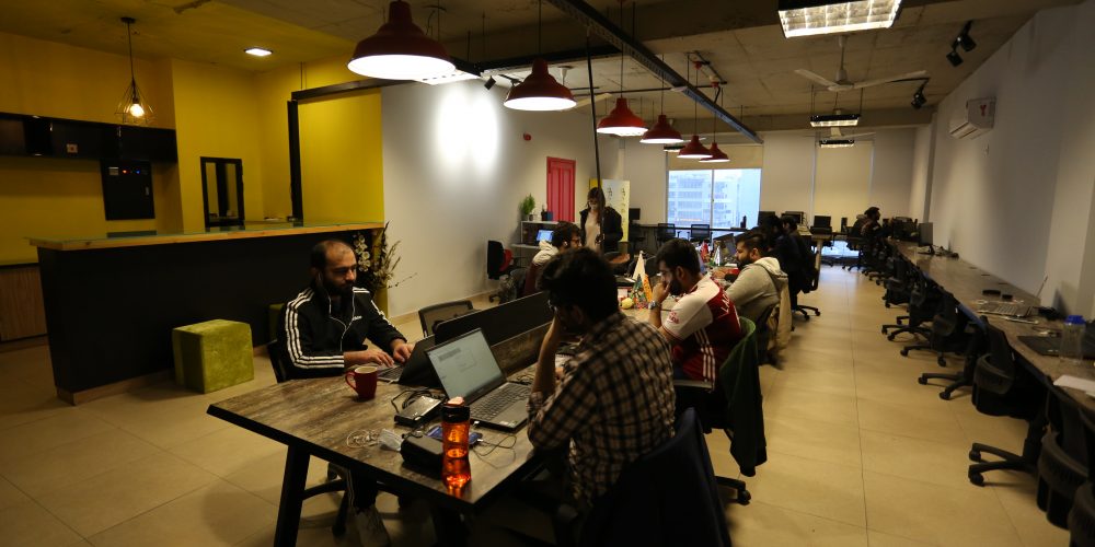Employees working in a coworking space of Huddle
