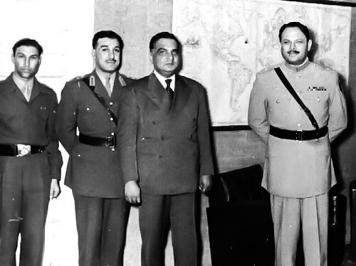 Iskandar Mirza standing with other important figures during his visit to Turkey