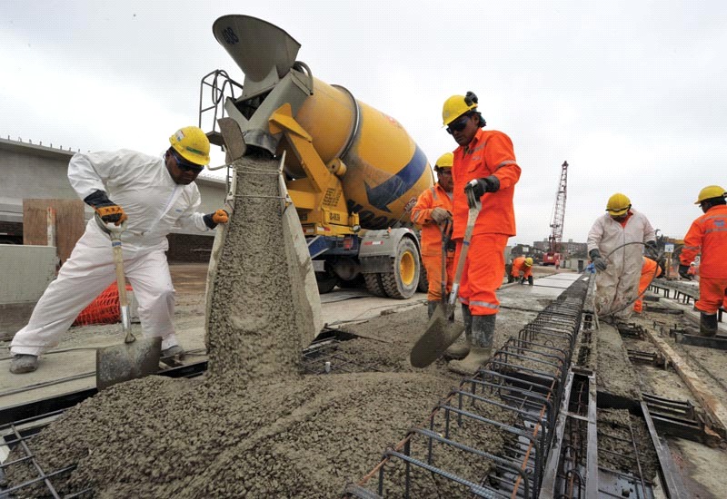 labors working on Ready mix concrete (RMC) machine