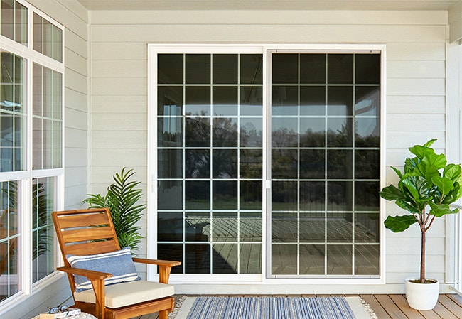 a covered sliding glass door in a balcony