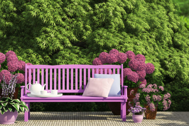 a pink bench in the middle of garden