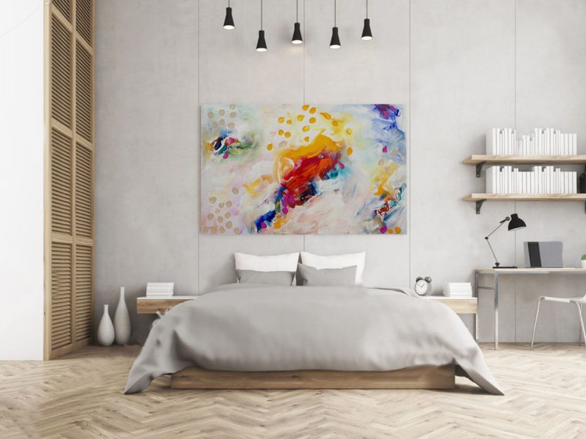 a room with Abstract Art above bed