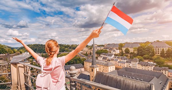 a girl waving Luxembourg