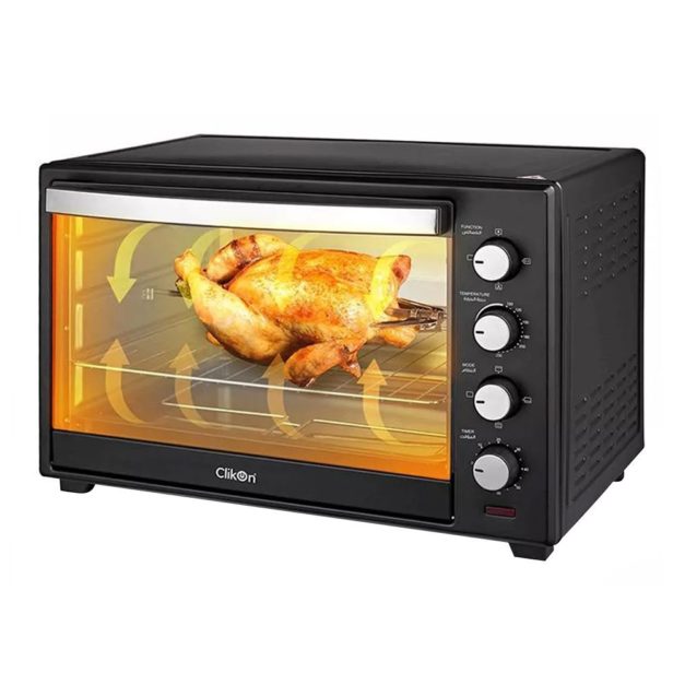 A chicken roasting in a toaster oven