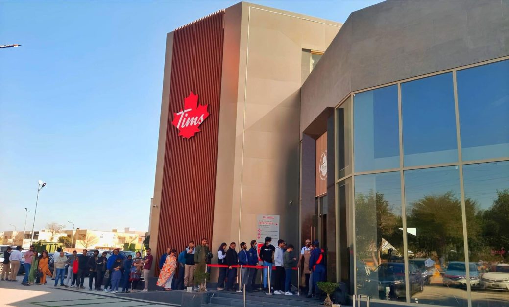 Cutomers waiting in a queue outside Lahore branch of Tim Hortons