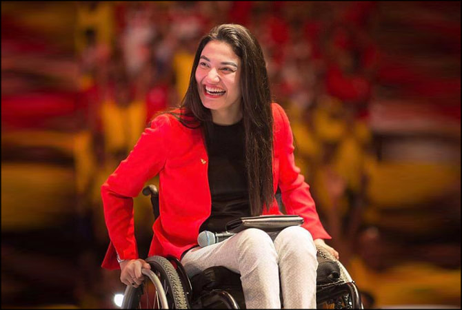 Muniba Mazari smiling on a wheel chair during TED talk