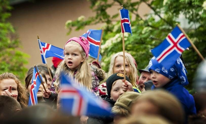 A little girl holding Iceland flag