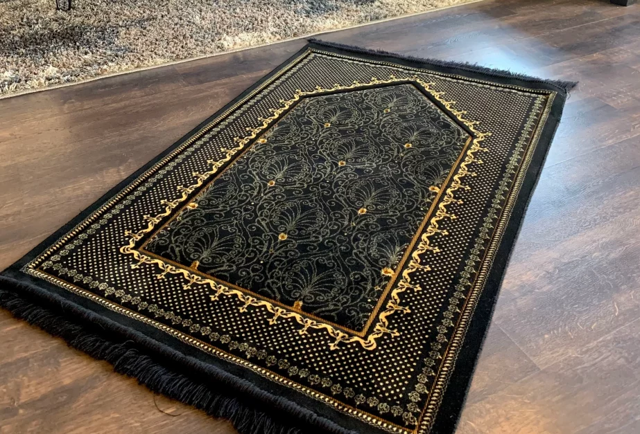 Prayer mat on the wooden floor