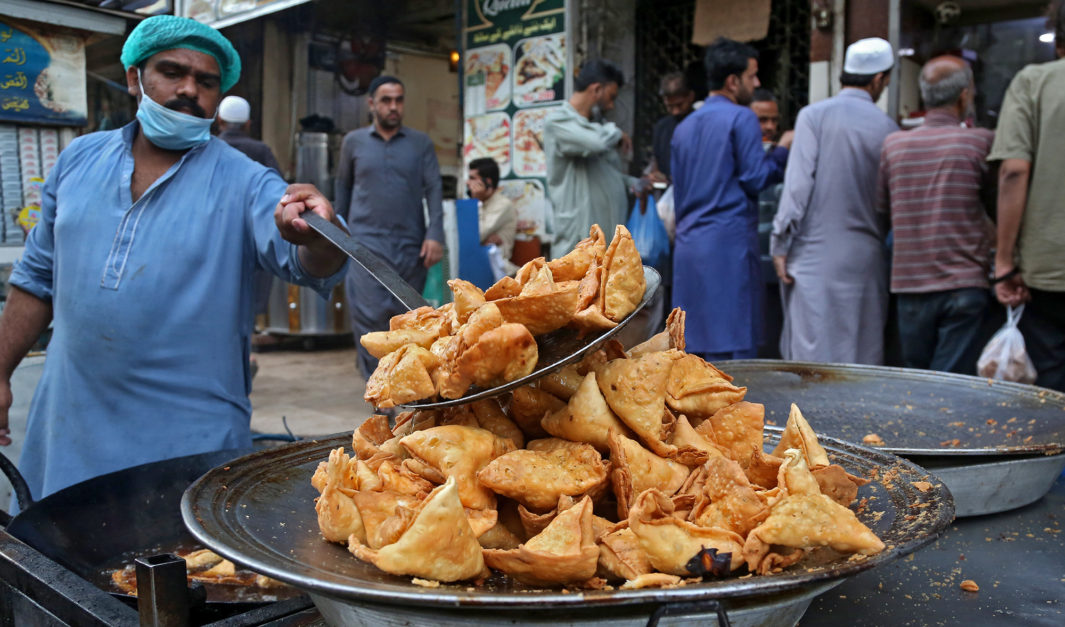 a man taking out samosas