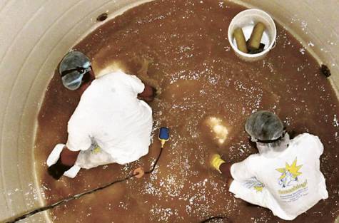 two persons cleaning Water Tank 