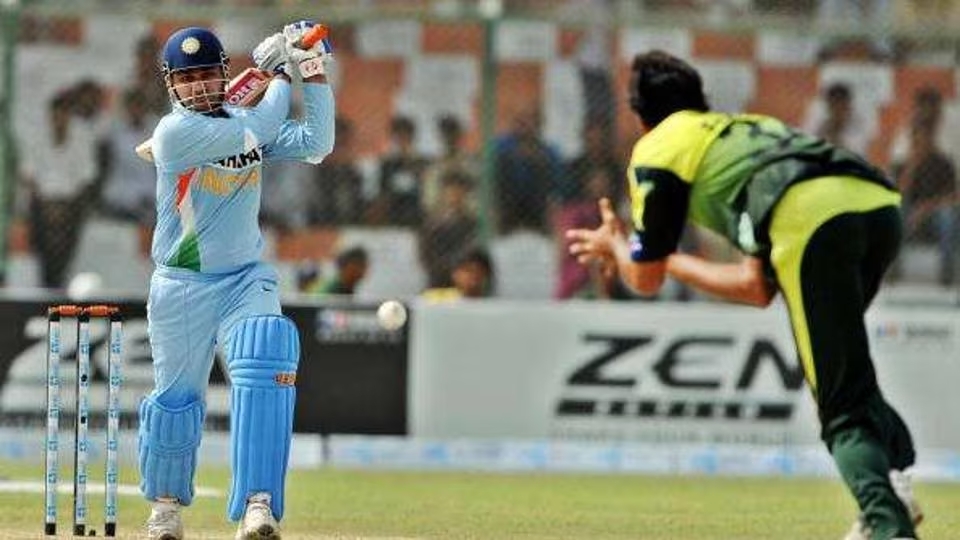 indian player batting and Pakistani bowler is in stance to catch the ball