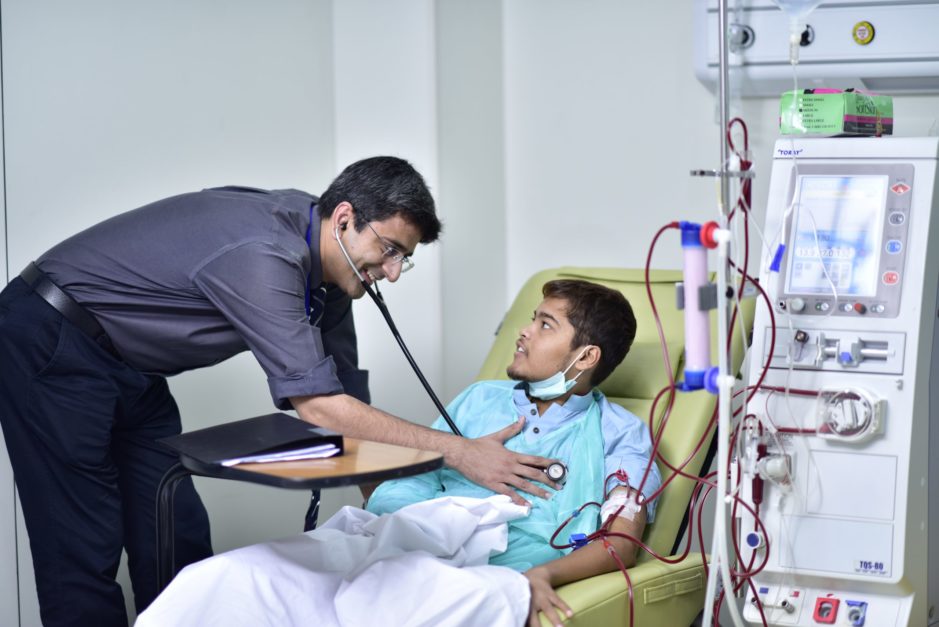 Doctor checking patient with stethoscope