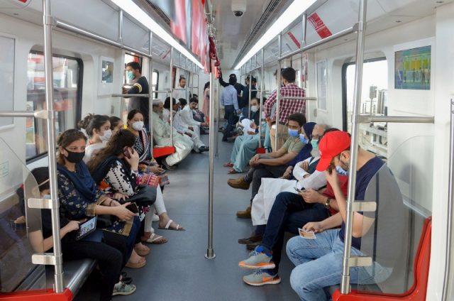 passengers sitting on seats in orange line train