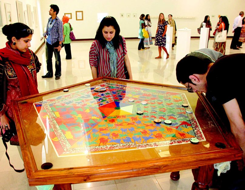 Students playing board game during the exhibition