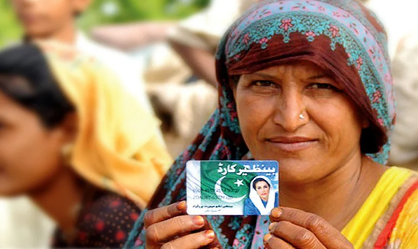 Women holding and showing Benazir Income Support Program card 