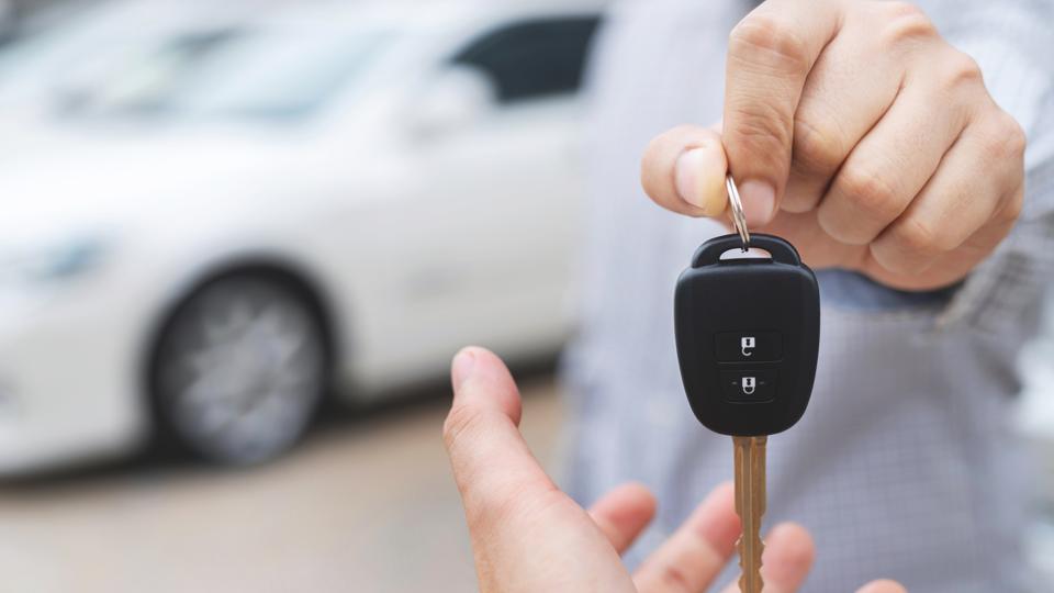 a person handing over key to another person