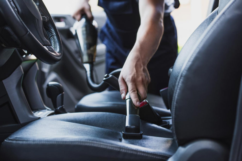 A man cleaning his car seats